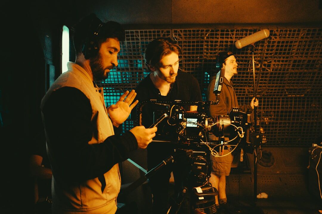 Technicians setting up studio camera and lighting equipment