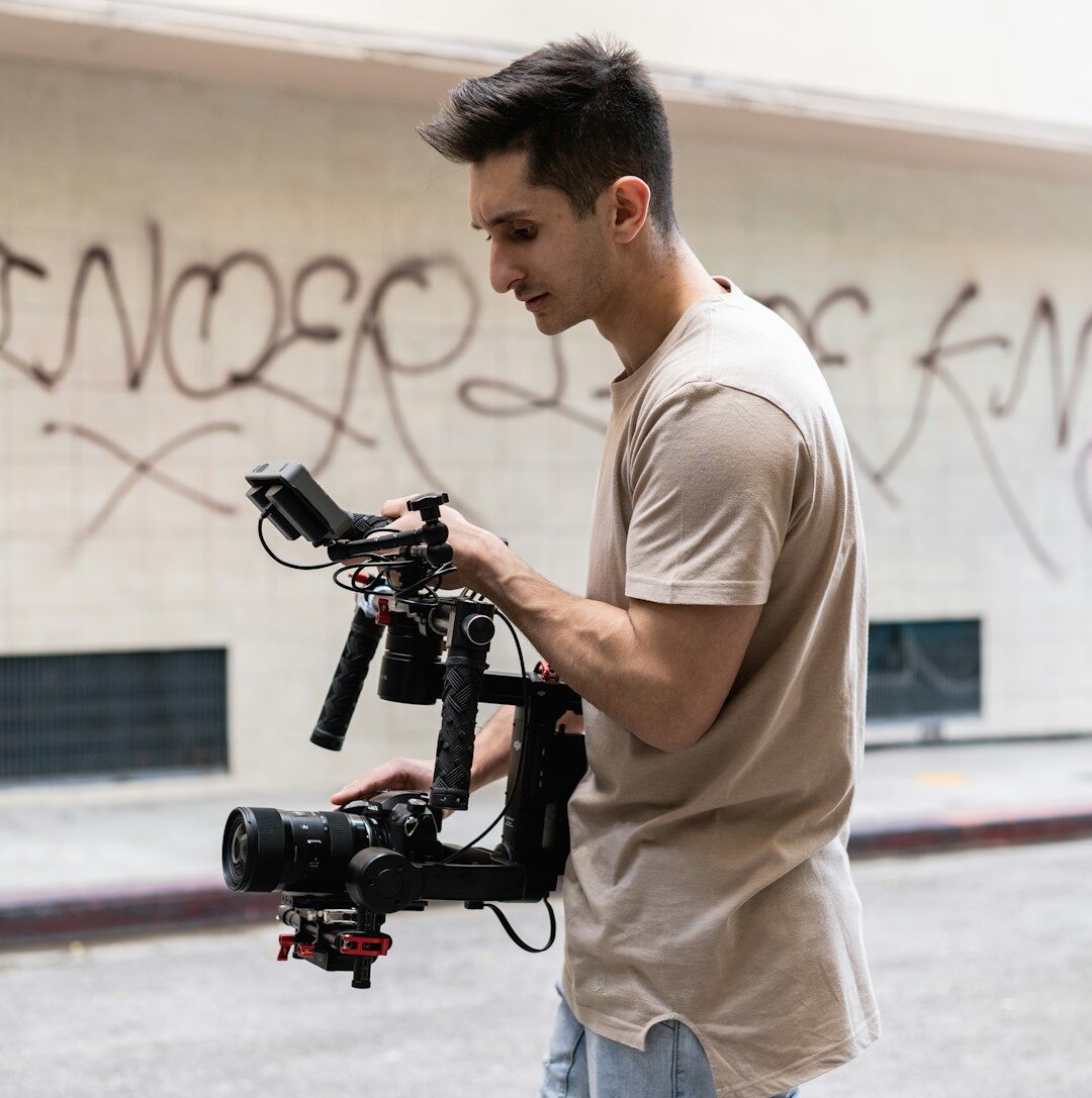 Portrait of a male camera operator holding a camera