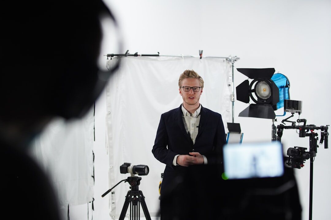 Presenter standing in front of a green screen studio wall