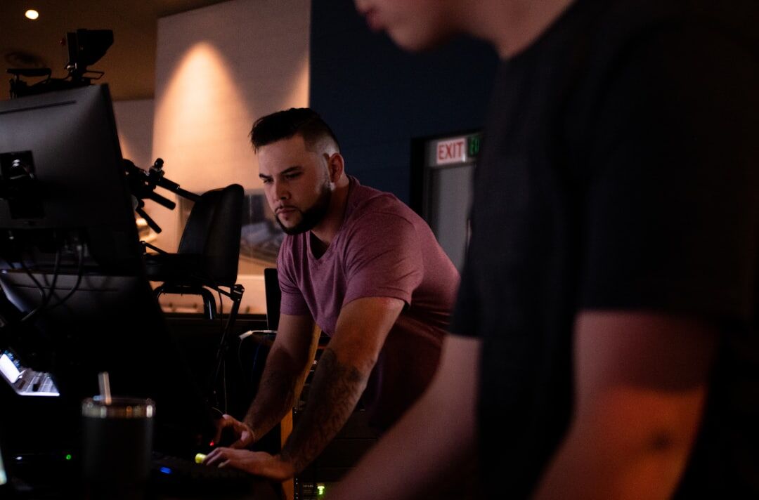 Production coordinator answering calls beside studio equipment